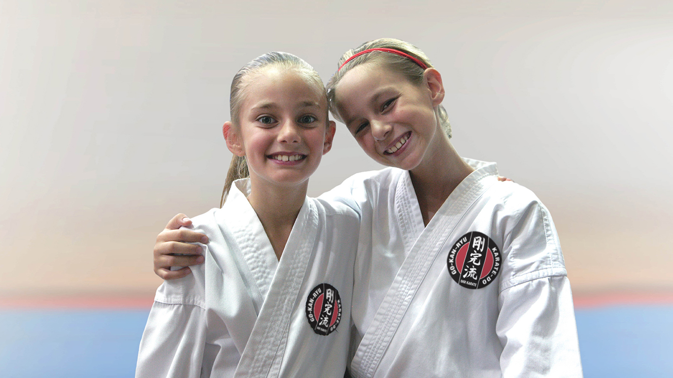 two girls wearing gkr karate gi posing for the camera. the search for happiness two girls wearing gkr karate gi posing for the camera. the search for happiness